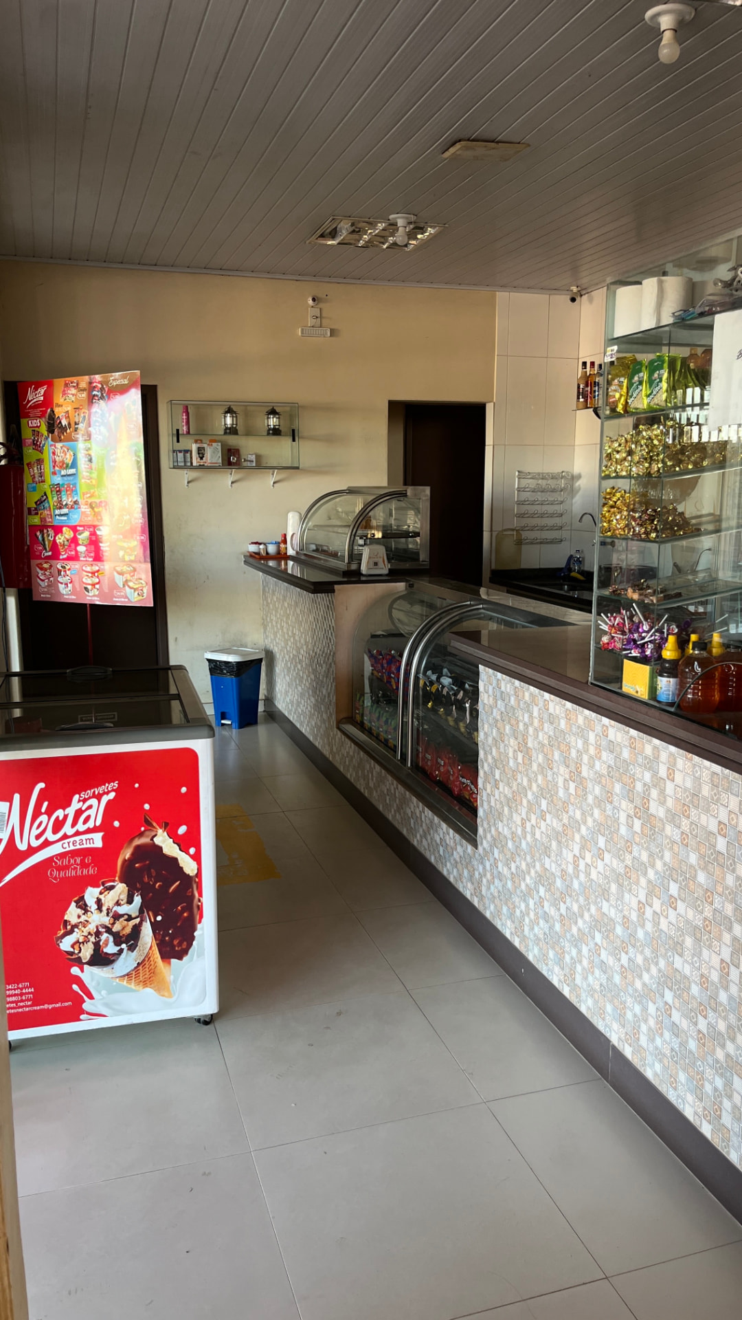 Balcão de sorvetes, doces e conveniência no espaço interno
